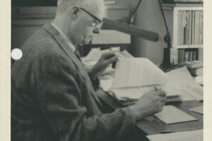 Dr. Arthur Lower reading at a desk