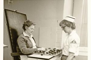 Two individuals playing a game as part of rehabilitation therapy