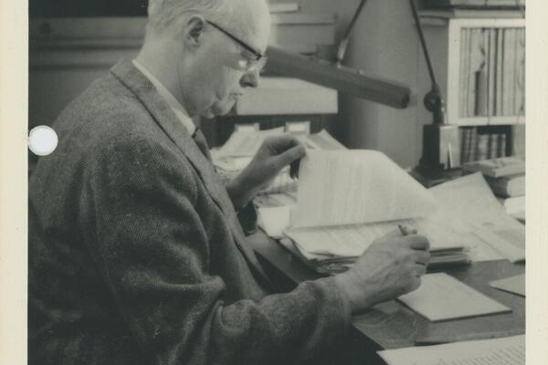 Dr. Arthur Lower reading at a desk